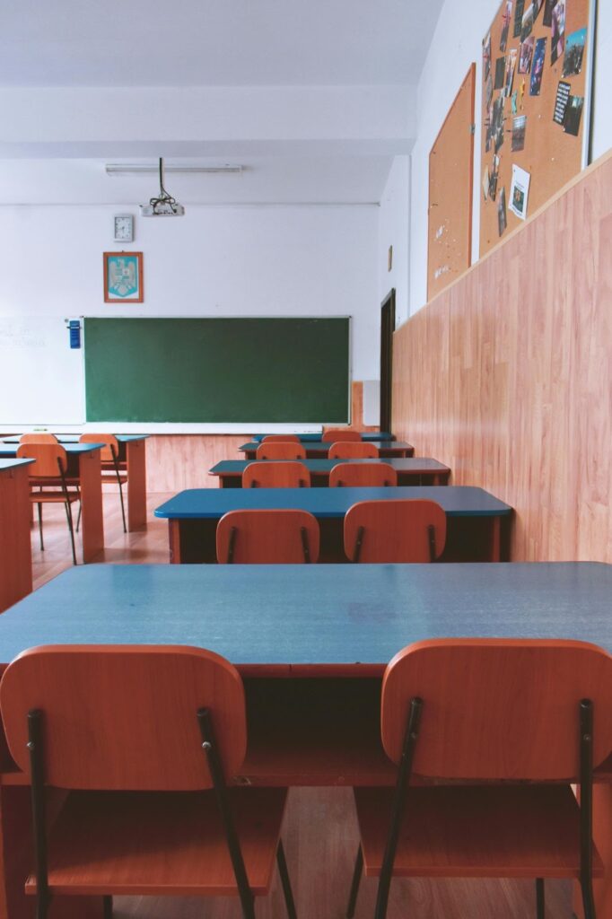 An empty school classroom during the daytime.
