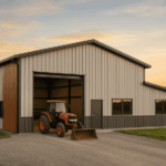 cold formed steel agricultural building with tractor outside door, sunset