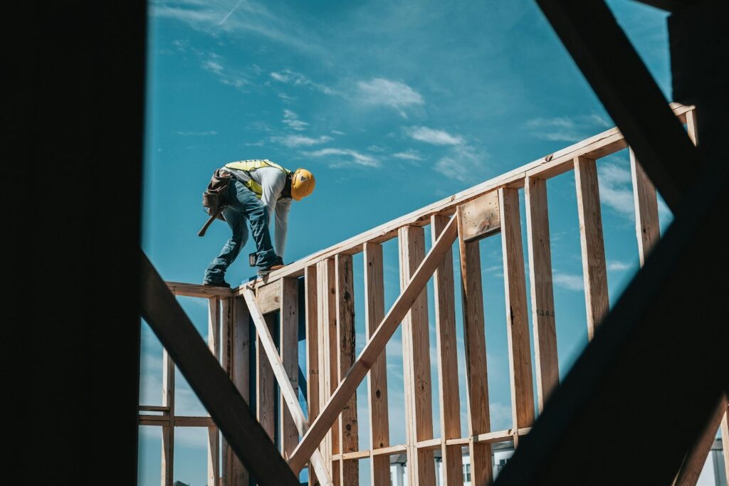Construction worker building a wooden building.