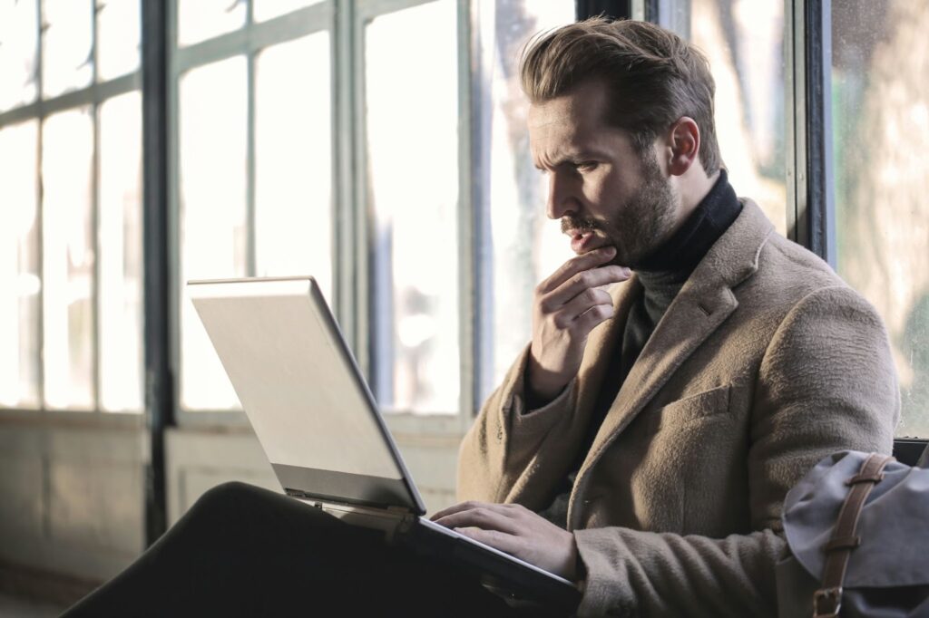 A man using his laptop in an office.