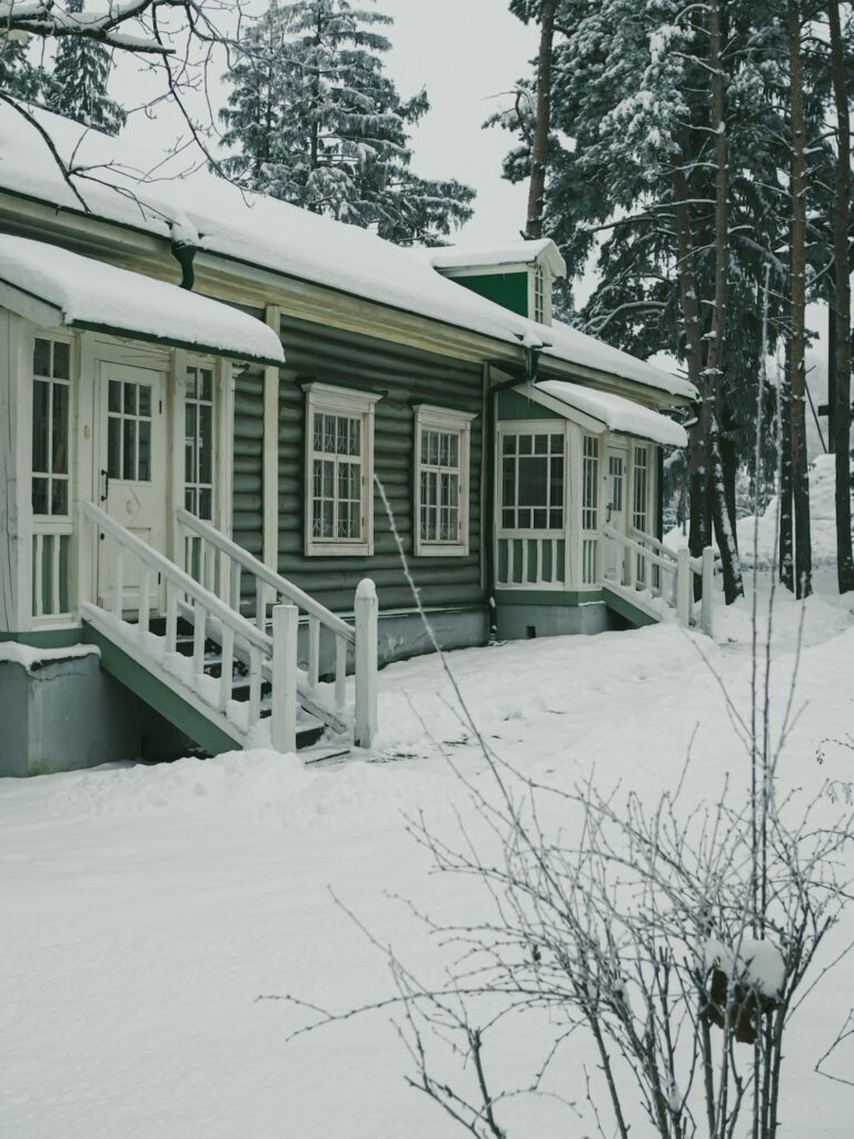 Metal building roof pitch: Snow-covered house with heavy snow on the roof.